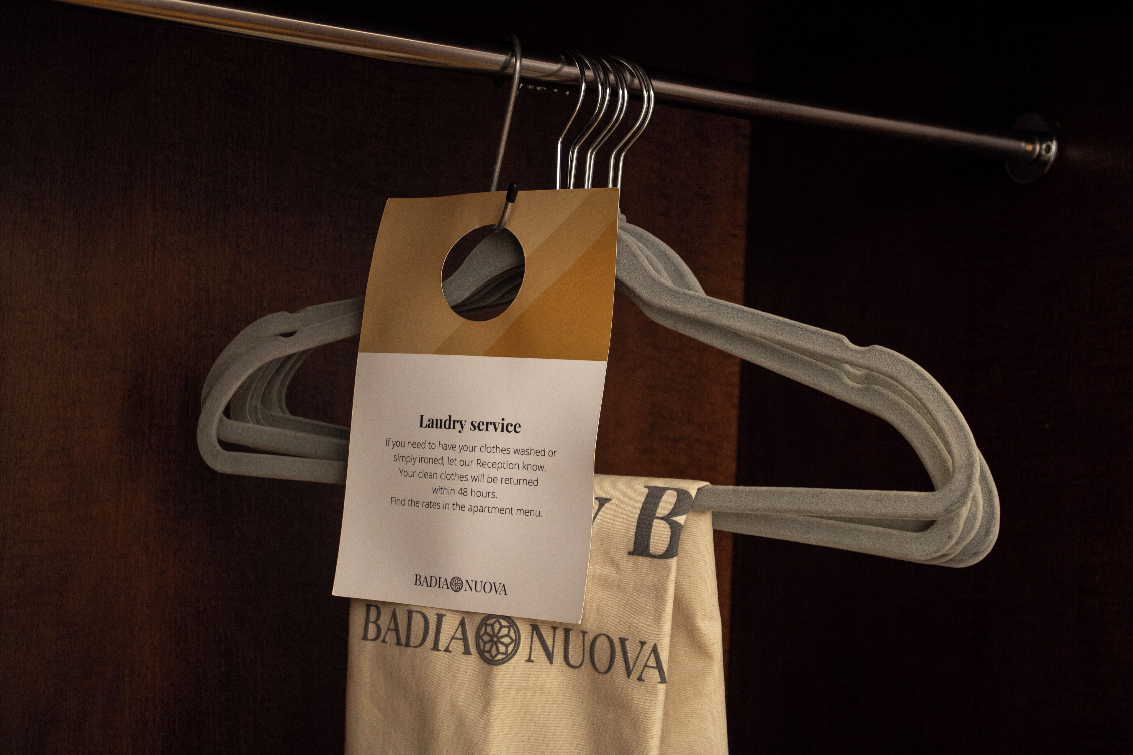 A tag hanging on a hanger with a message about laundry service.