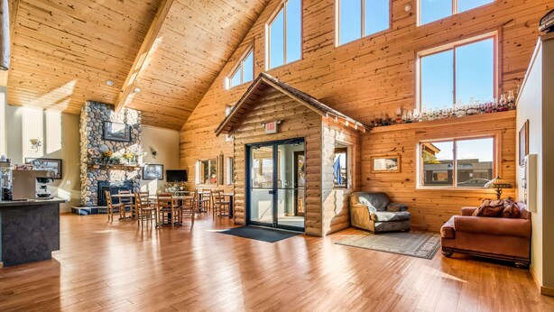 A spacious log cabin with a dining area, kitchen, and seating area. - Econo Lodge Rice Lake (Rice Lake)