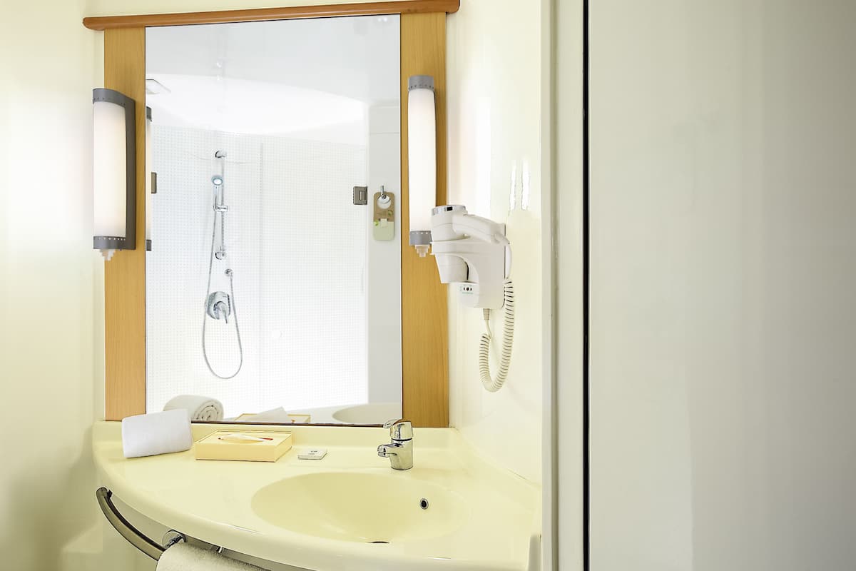 room, multiple beds | bathroom | shower, eco-friendly toiletries, hair dryer, towels