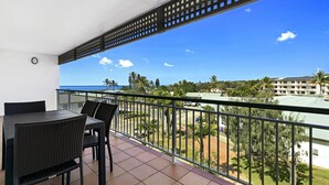 A balcony with a view of the ocean and palm trees. - K'gari Beach Resort (Eurong)