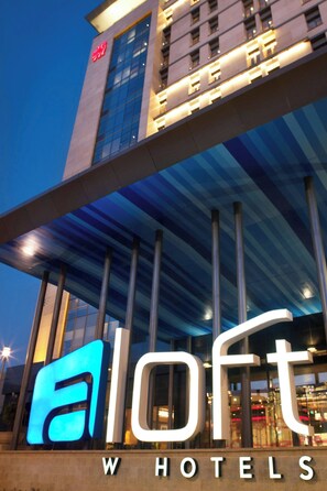 A modern hotel with a prominent 'aIoft' sign, large windows, and a distinctive architectural design. - Aloft Beijing, Haidian (Beijing)