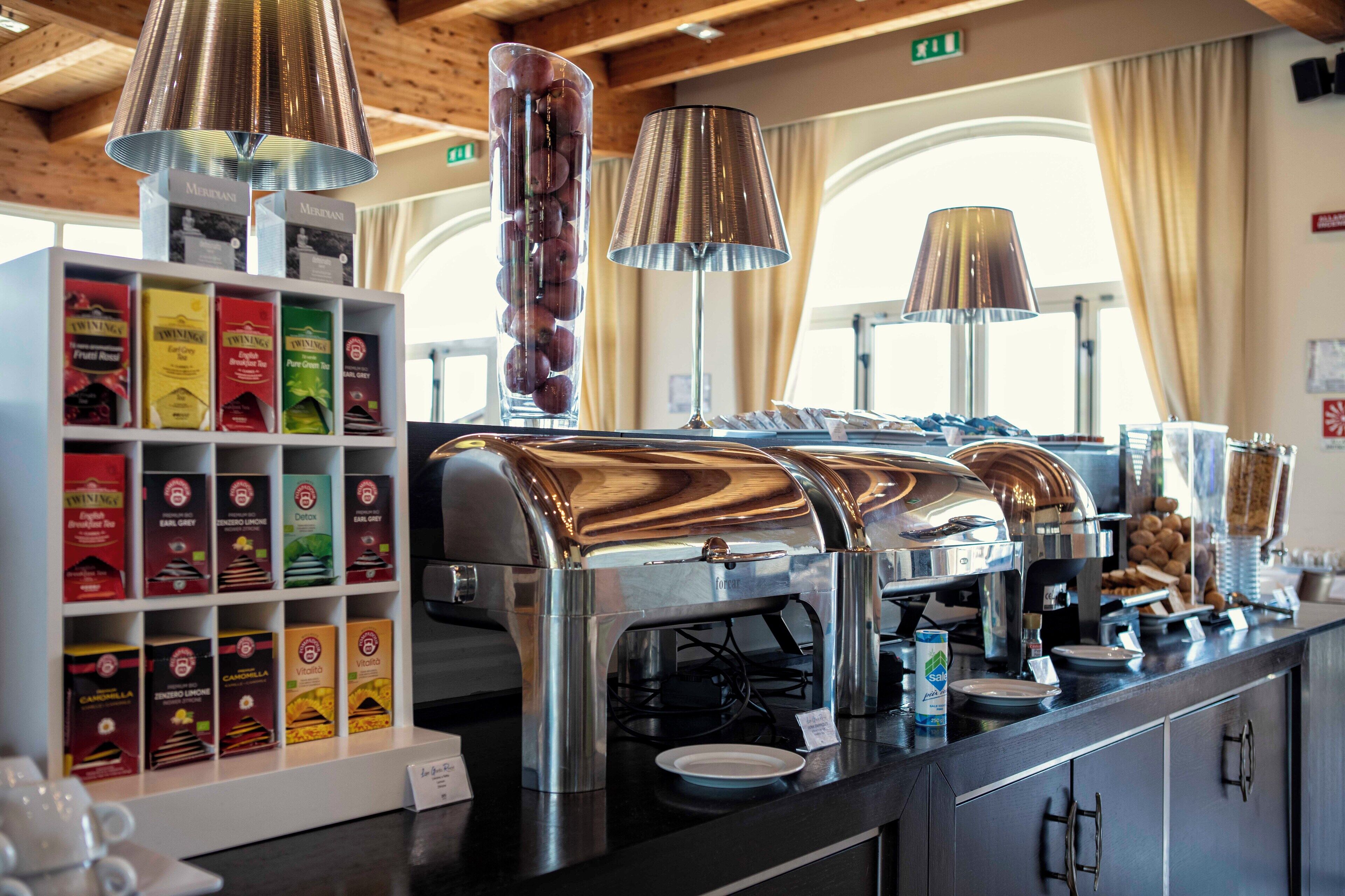A breakfast bar with a selection of packaged foods, a coffee station, and a view of the interior.