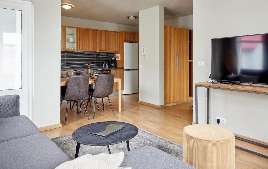 Un apartamento moderno con sala de estar, comedor y cocina.