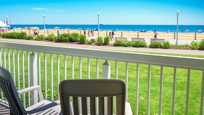 A view from a balcony overlooking a beach with a clear sky. - The Oceanfront Inn (Virginia Beach)