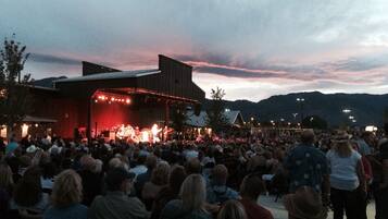 A concert stage with a crowd of people in front.