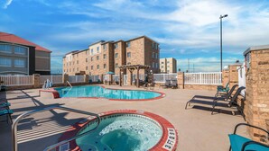 A rooftop pool area with a hot tub, lounge chairs, and a pergola. - Comfort Suites Corpus Christi Central (Corpus Christi)