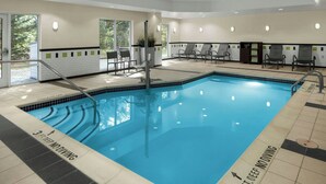 A swimming pool with a 3 ft deep no diving sign, lounge chairs, and a sunning area. - Fairfield Inn & Suites by Marriott Carlisle (Carlisle)