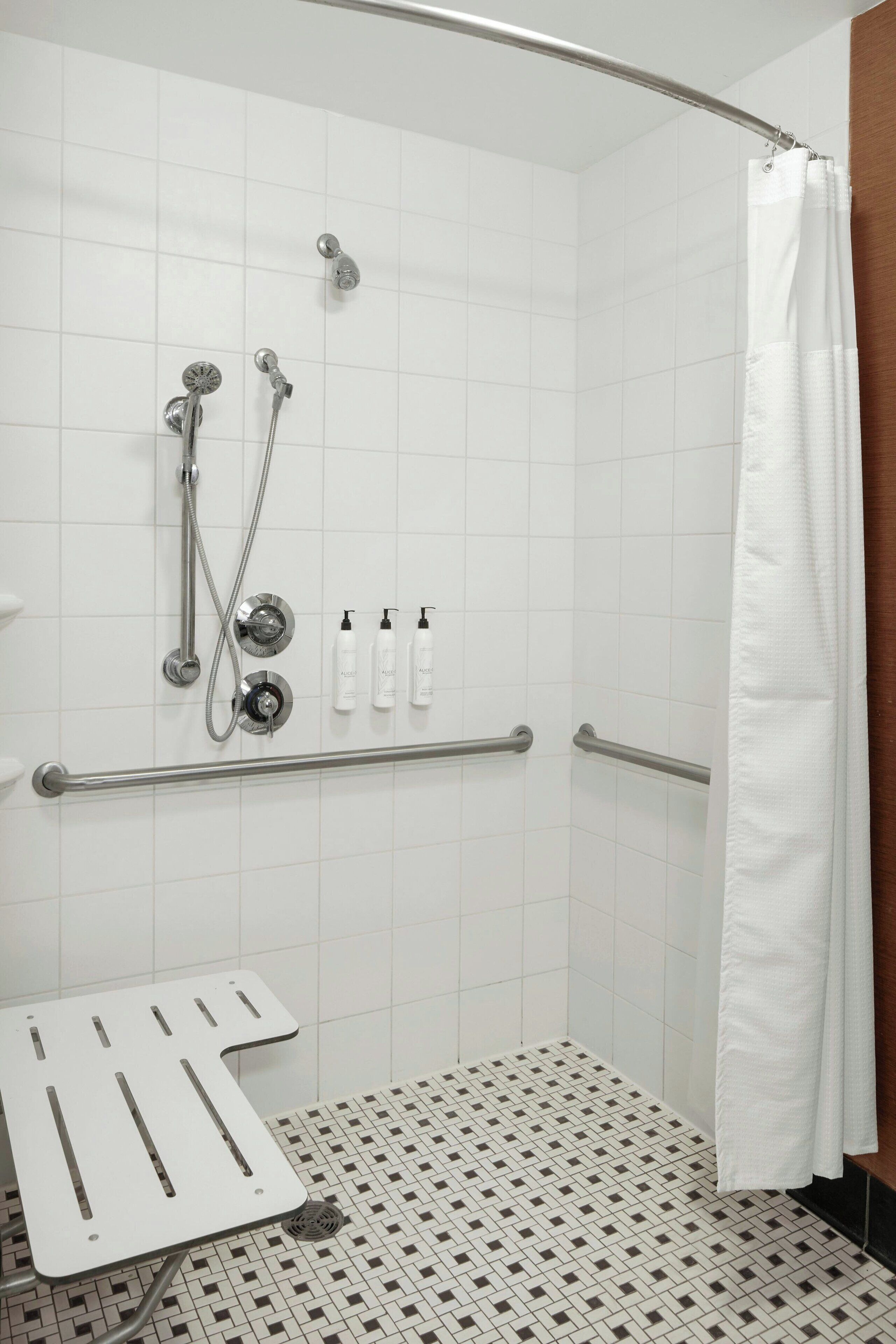 room, 1 king bed, non smoking (mobility/hearing access, roll-in shwr) | bathroom | combined shower/bathtub, free toiletries, hair dryer, towels