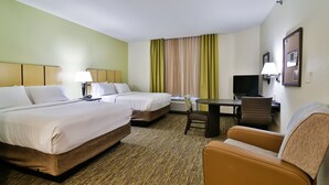 A hotel room with two beds, a desk, a chair, and a television.