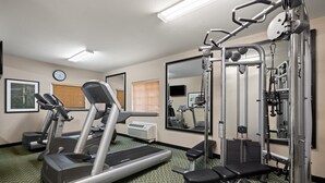 A gym with a treadmill, weight bench, and various exercise machines. - Candlewood Suites Bismarck by IHG (Bismarck)