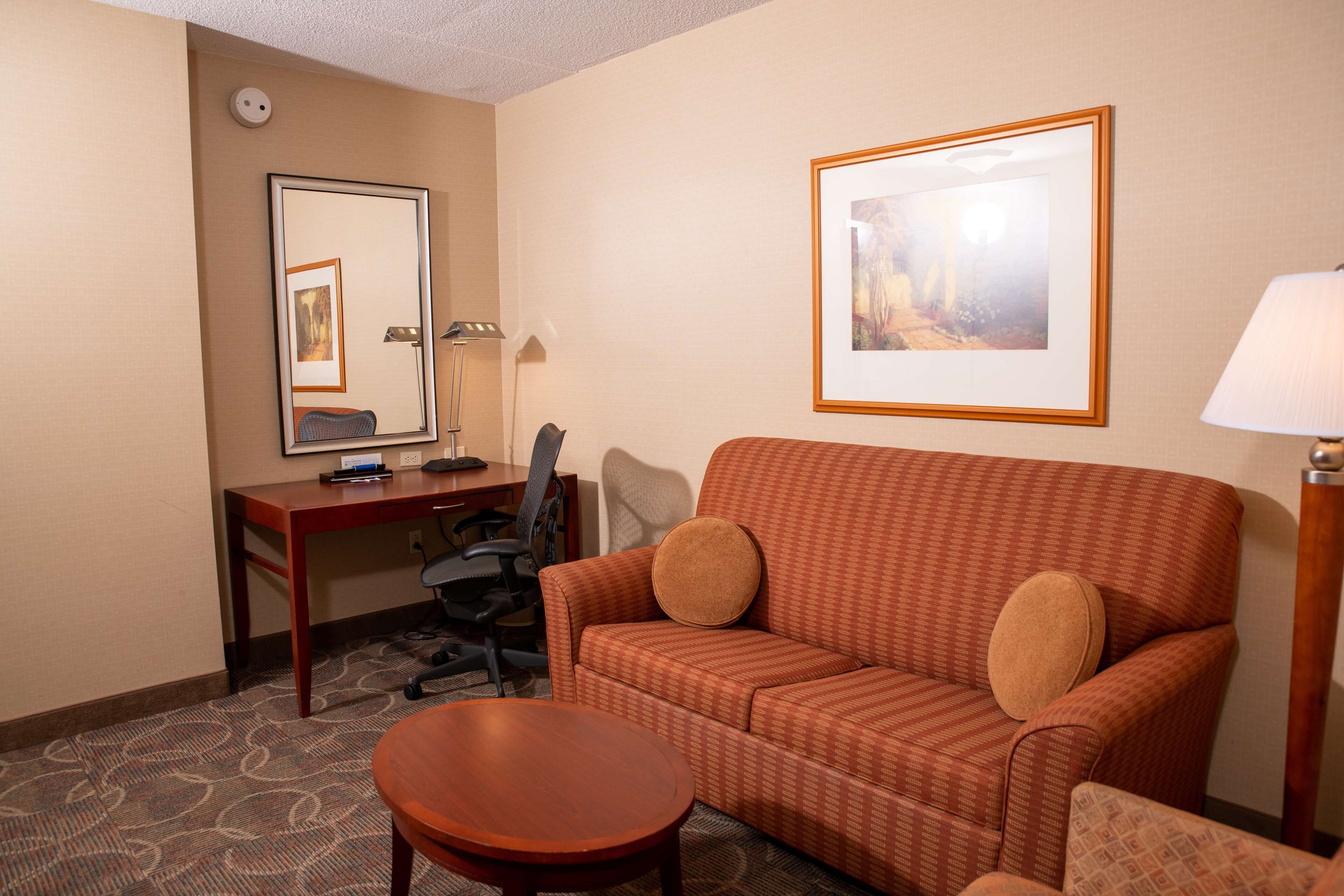 two queens evolution junior suite | living area | 32-inch flat-screen tv with satellite channels, tv, pay films