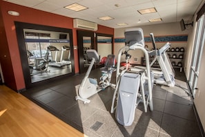 A gym with treadmills, elliptical machines, and a wall of dumbbells. - Hampton Inn & Suites Tilton (Tilton)