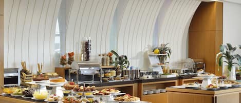 A buffet with various food items and a modern interior design.