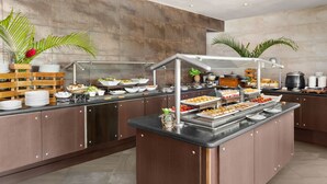 A buffet setup with various food items and a coffee station. - Holiday Inn Panama Canal by IHG (Panama City)