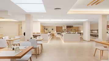 A modern, well-lit dining area with white furniture and a central kitchen in the background.
