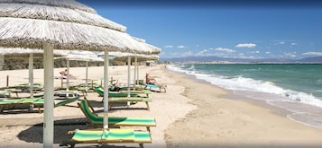 Beach nearby, white sand, sun loungers, beach towels
