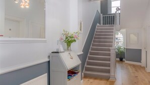 A staircase with a grey railing leading to a landing. - The Montana (Torquay)