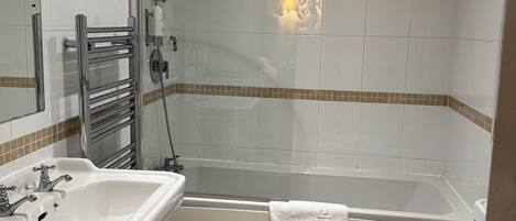 A modern bathroom with a bathtub, a sink, and a toilet.