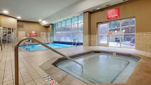 An indoor swimming pool with a hot tub, clear signage, and a view of the outside. - Drury Inn & Suites Charlotte Northlake (Charlotte)