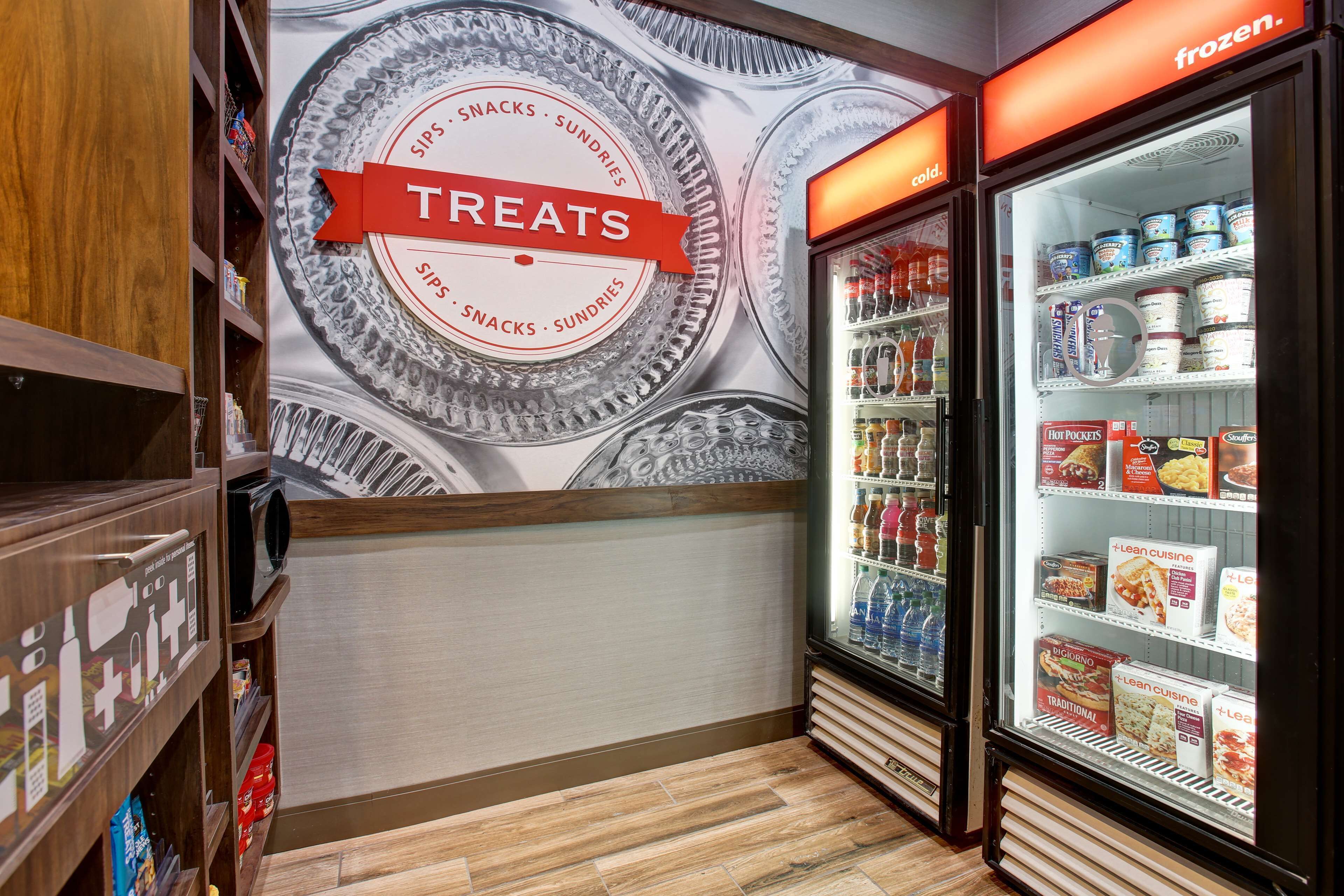 A refrigerated display case labeled "TREATS" with various frozen food items.