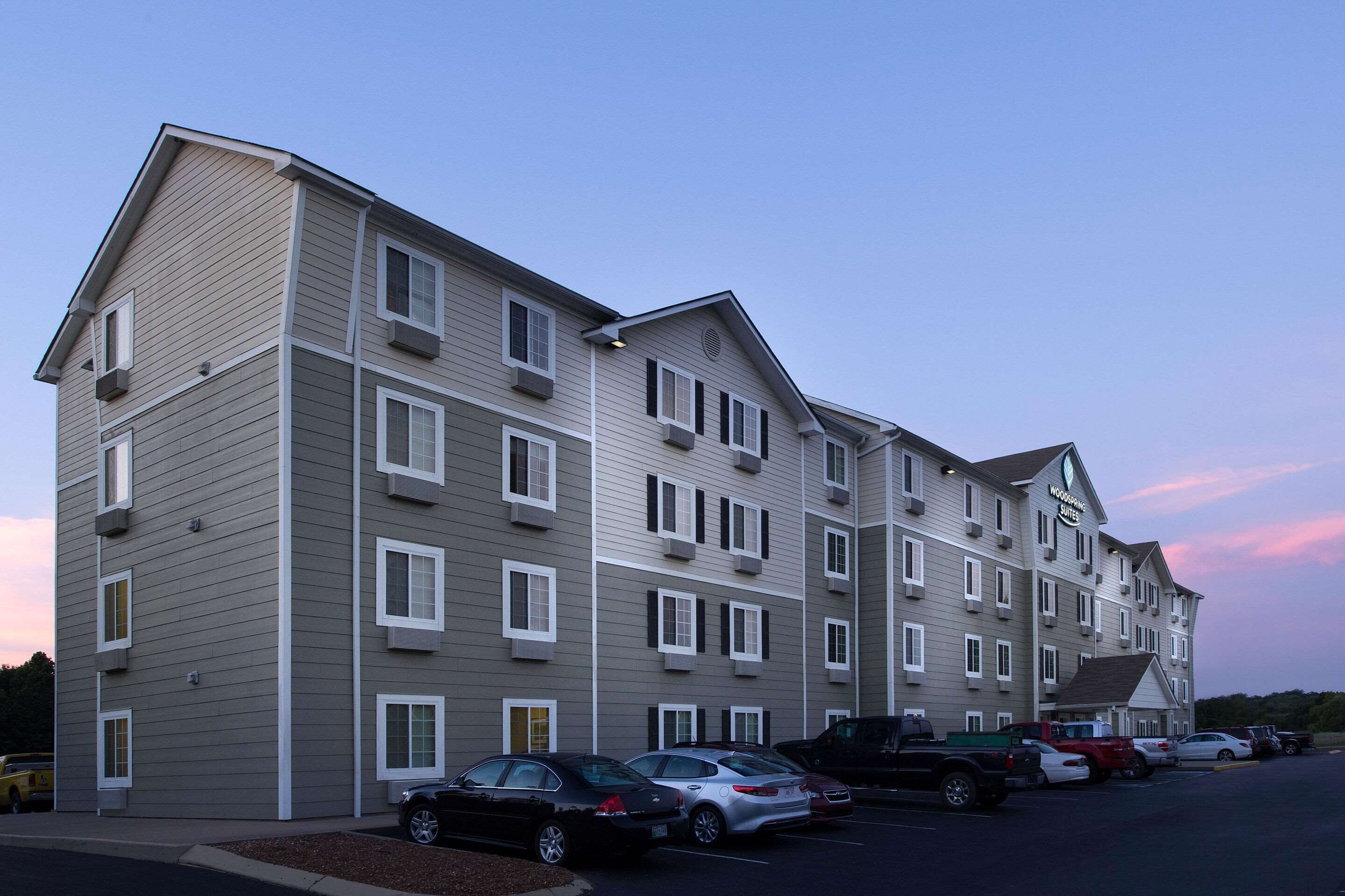 A multi-story hotel with a parking lot.