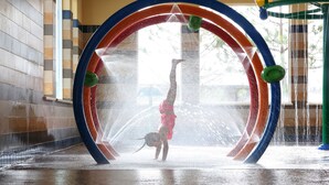 A water play area with a circular water feature and a person performing a handstand. - Driftwood Shores Resort And Conference Center (Florence)