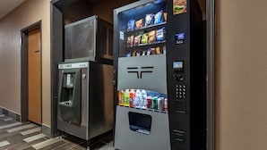 A vending machine with a water dispenser and a selection of snacks and drinks. - Quality Inn Redgranite (Redgranite)