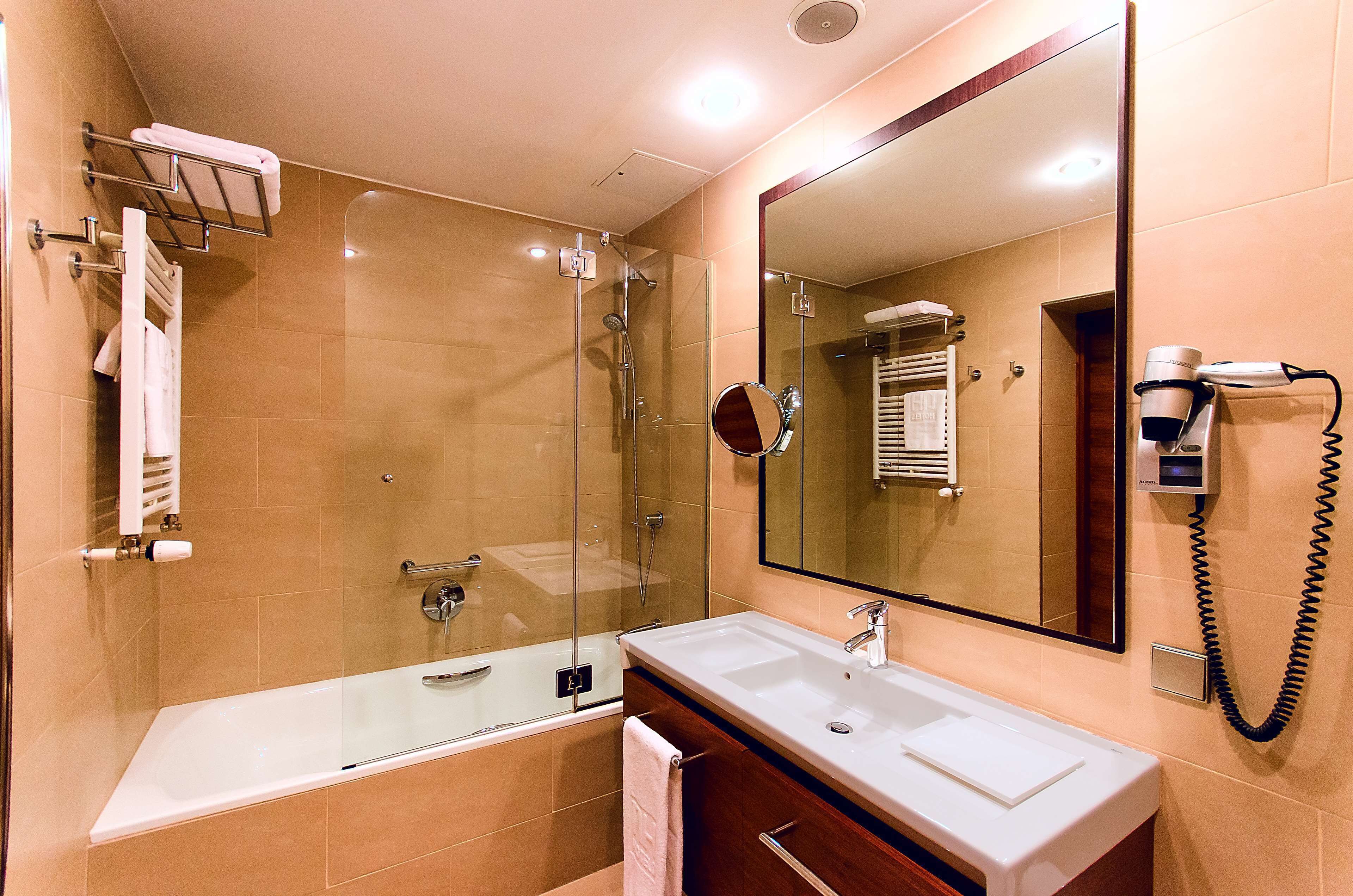 deep-soaking bathtub, eco-friendly toiletries, hair dryer, towels