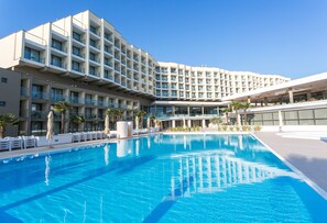A modern hotel with a large pool, multiple balconies, and a clear blue sky. - Hotel Materada Plava Laguna (Porec)