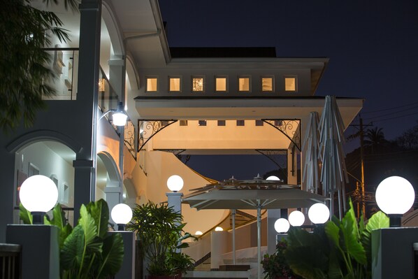 A modern building with a covered entrance, multiple windows, and outdoor lighting. - Bacolet Beach Club (Scarborough)