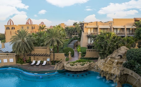 Outdoor pool, pool loungers. The Corinthians Resort