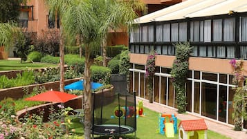 Relax in our serene courtyard surrounded by lush gardens and play structures for kids.