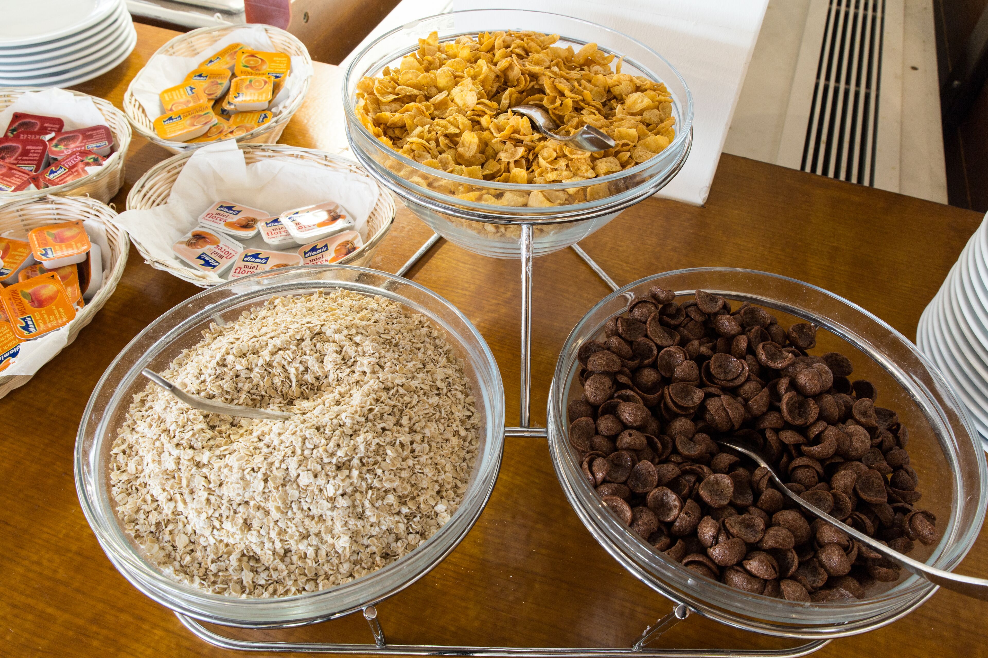 A buffet table with various food items including cereal, chocolate, and other snacks.