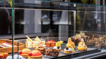 A variety of desserts displayed in a glass case.