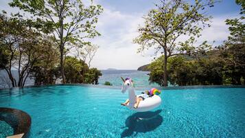 Outdoor pool, pool umbrellas, lifeguards on site