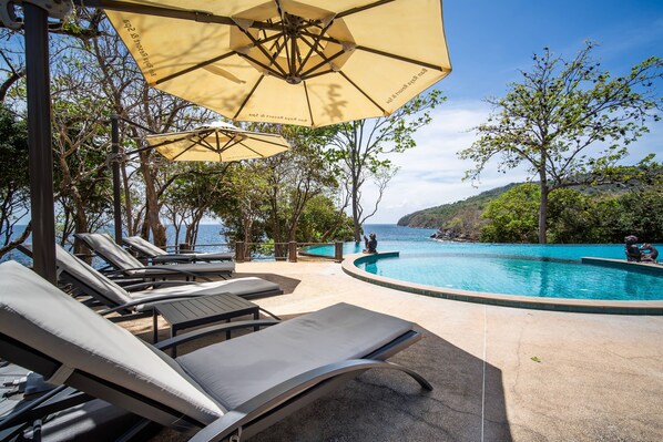 Outdoor pool, pool umbrellas, lifeguards on site