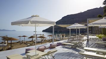 On the beach, sun-loungers, beach umbrellas, beach towels