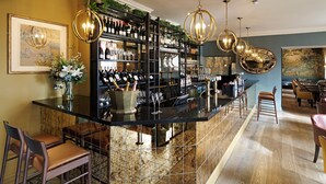 A bar area with a wine rack, bar stools, and a seating area with tables and chairs.