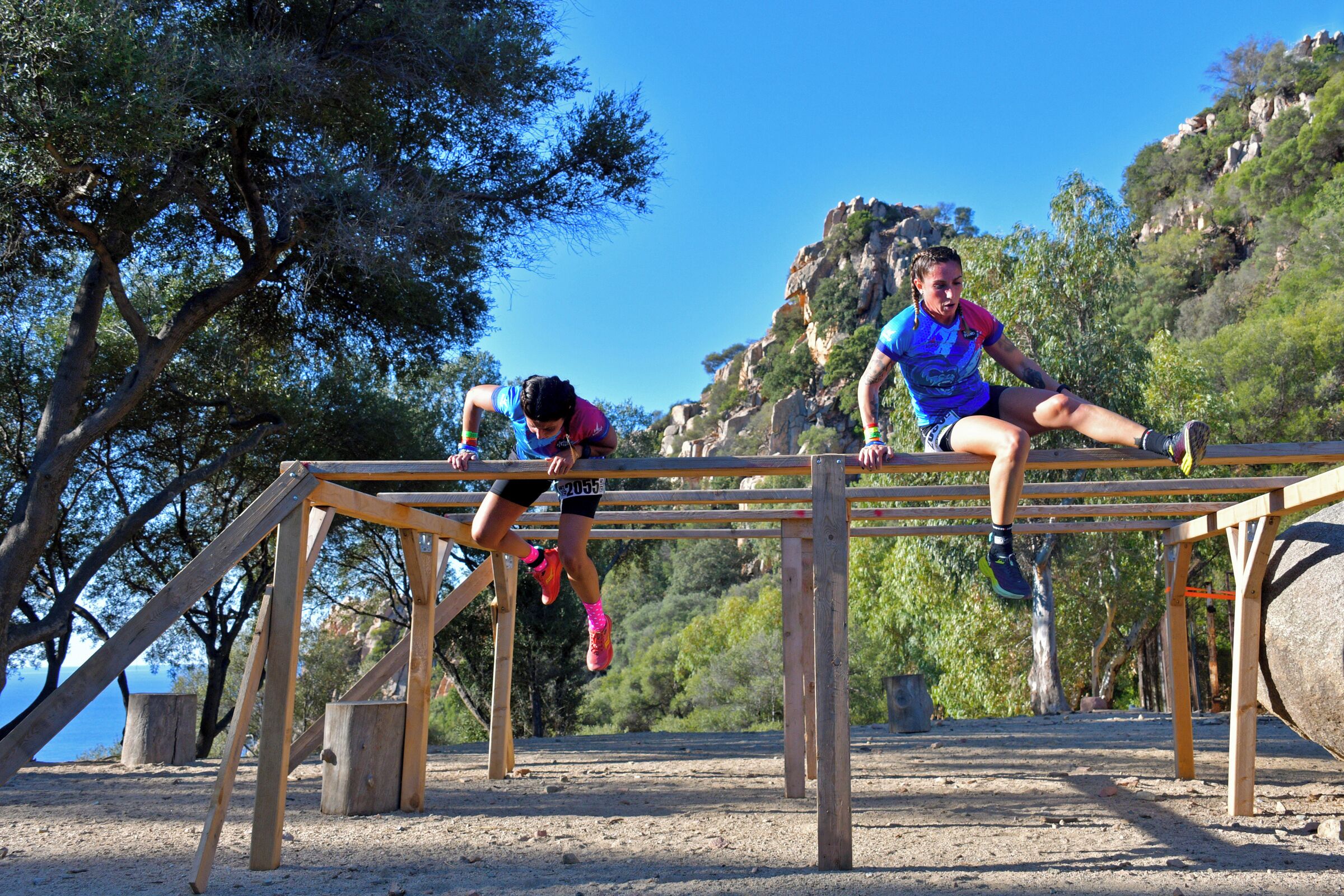 A wooden structure with two people performing exercises.