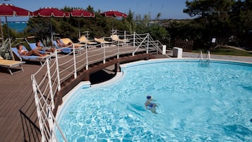 Alberca al aire libre y camastros