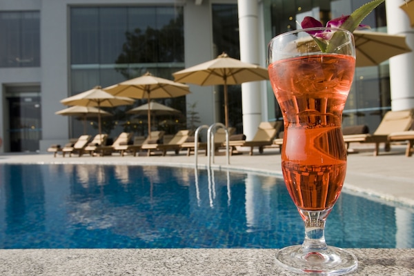 Outdoor pool, open 6:00 AM to 10:00 PM, pool umbrellas, pool loungers