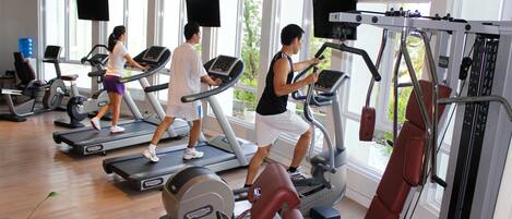 A gym with treadmills, weight machines, and exercise equipment.