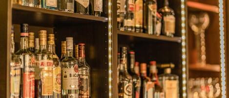 Shelves stocked with various liquor bottles, including brands like Hendrick's Gin and Bacardi.