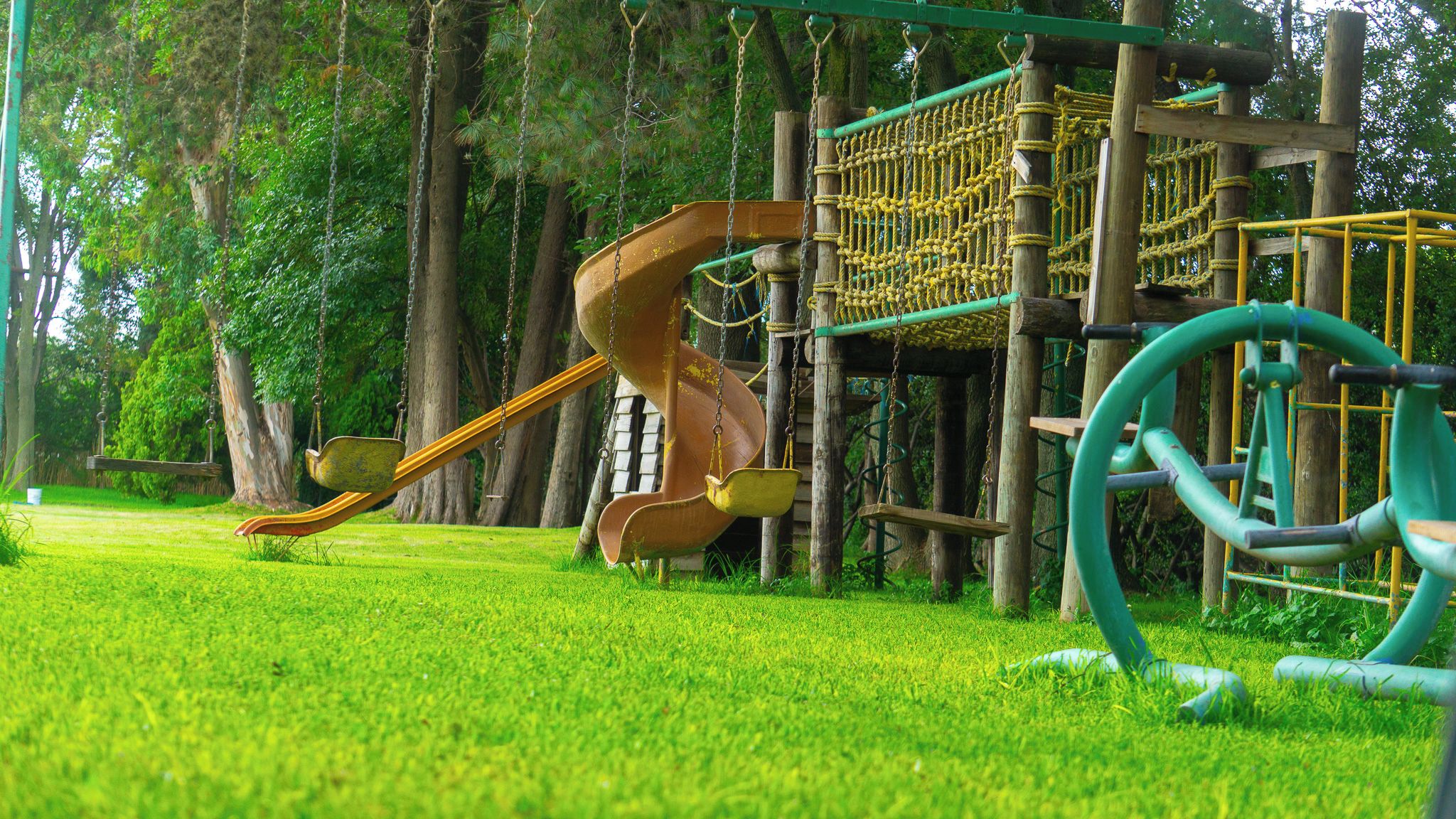 A playground with a slide and climbing structures.