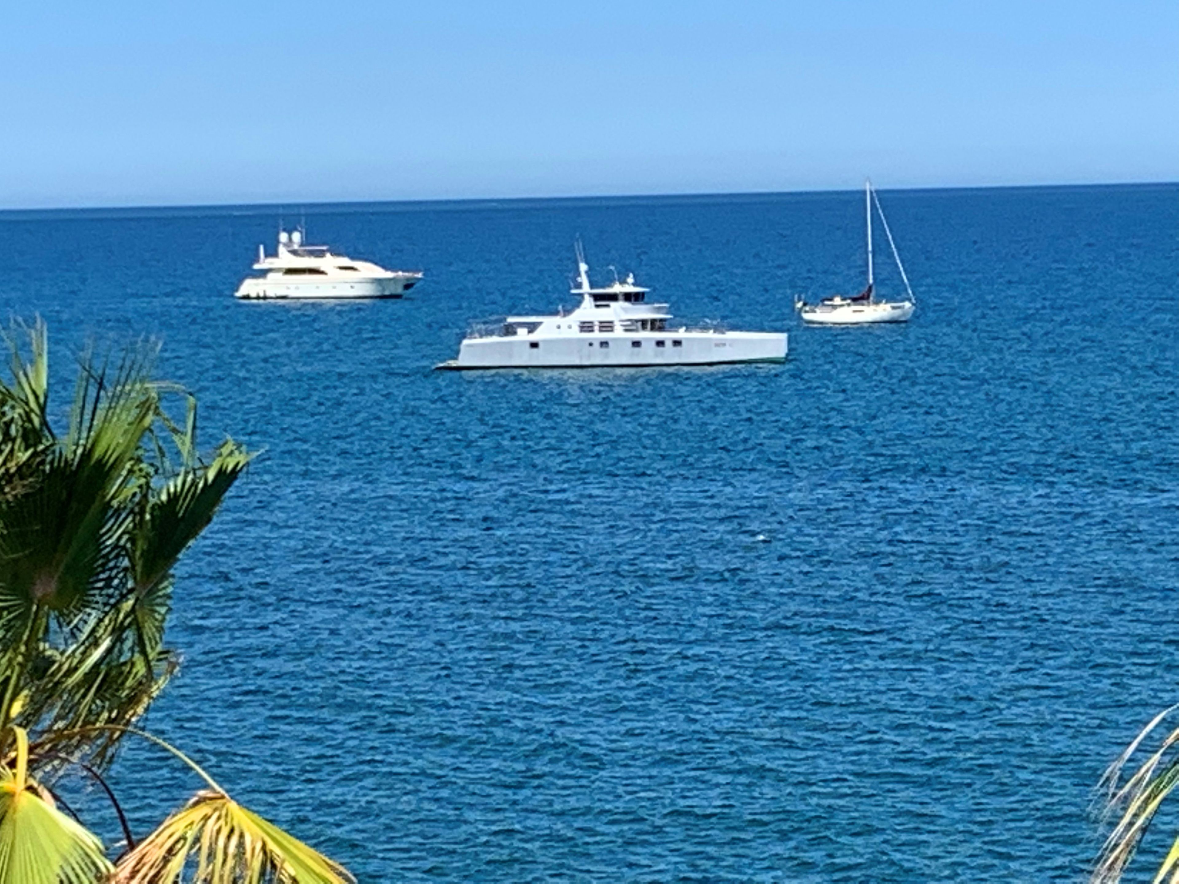 A marina with several yachts docked.
