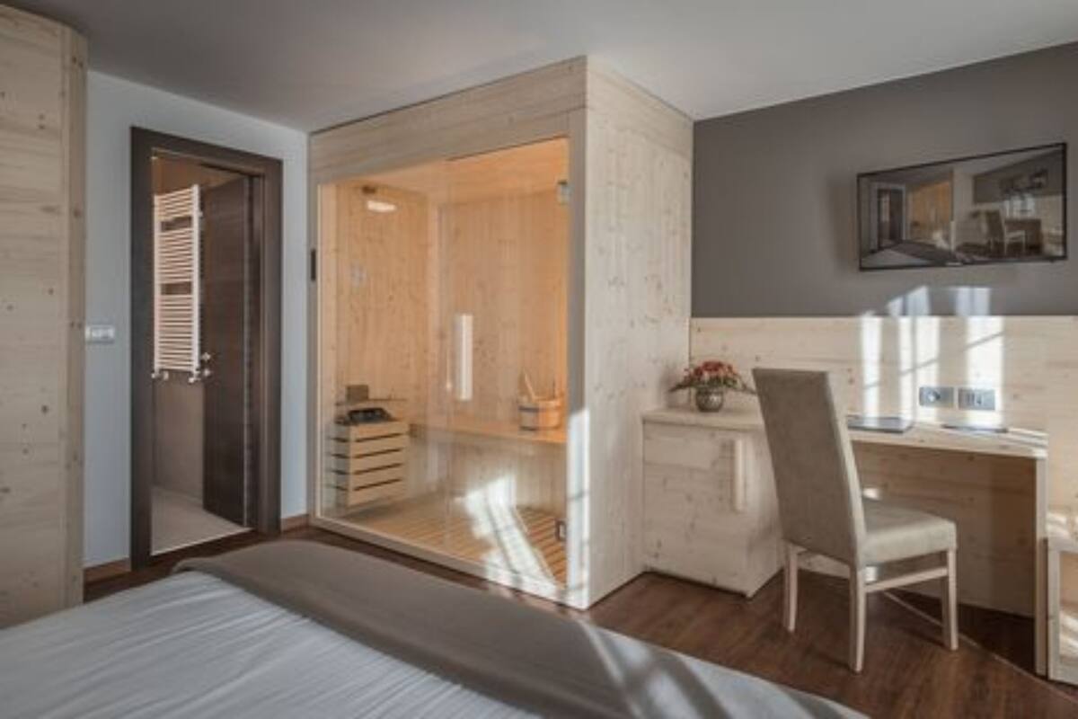 Une chambre moderne avec un grand lit, un bureau avec une chaise et un dressing.