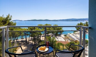 Family room with seaside balcony | Minibar, in-room safe, desk, blackout drapes