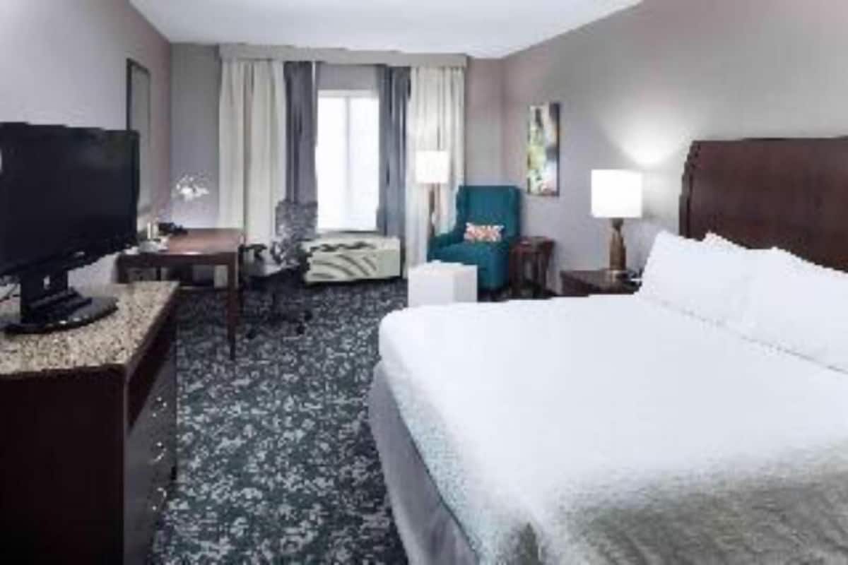 Premium bedding, desk, laptop workspace, blackout curtains