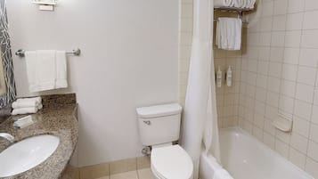 A bathroom with a sink, toilet, and bathtub.