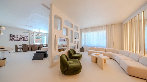 A modern living room with a sectional sofa, green armchairs, and a dining area with a table and chairs. - Destino Five Ibiza - 5-Star Grand Luxe Resort - Free Entrance to Pacha Club (Santa Eulalia del Rio)
